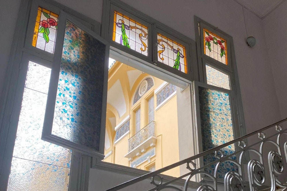 The stained-glass windows add a touch of brilliance to the space, especially during the day when sunlight streams through